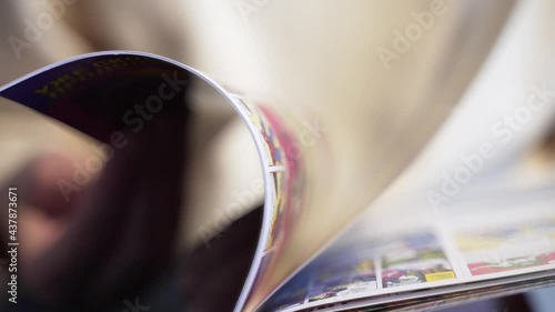 4K 10 bit. Person flips comic book. Fantastic images drawn in the book. Superheroes in comic