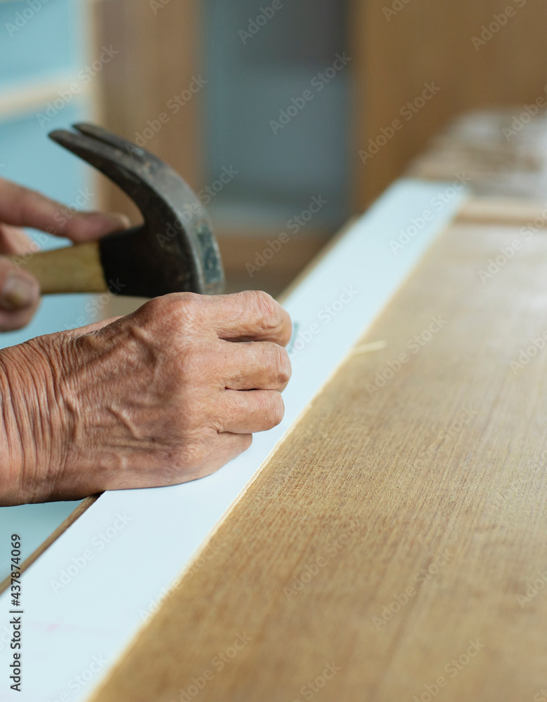 A craftsman is working on repairing wood. A craftsman is working on repairing wood.