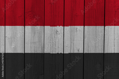 The National Flag of Yemen painted on a wooden wall. 