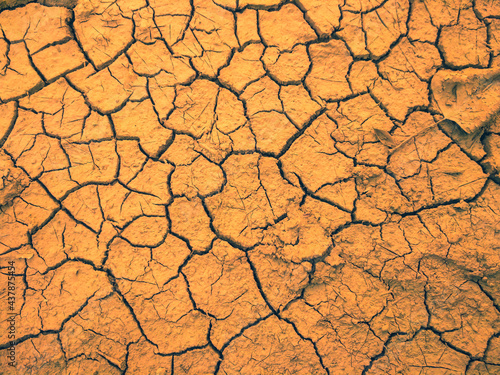 The clay ground has cracks in the top view for the background or graphic design with the concept of drought and death.