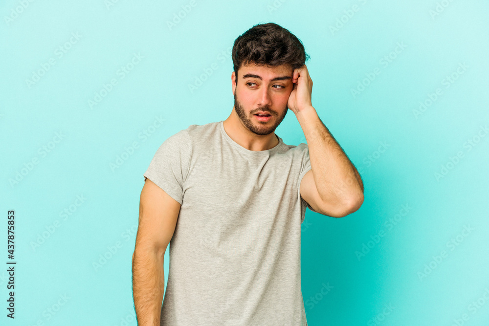 Young caucasian man isolated on blue background being shocked, she has remembered important meeting. Young caucasian man isolated on blue background being shocked, she has remembered important meeting.