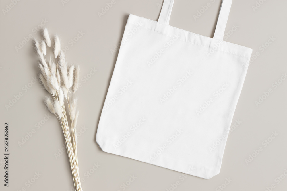 White tote bag mockup with a lagurus decoration on the beige background.  Stock-bilde | Adobe Stock