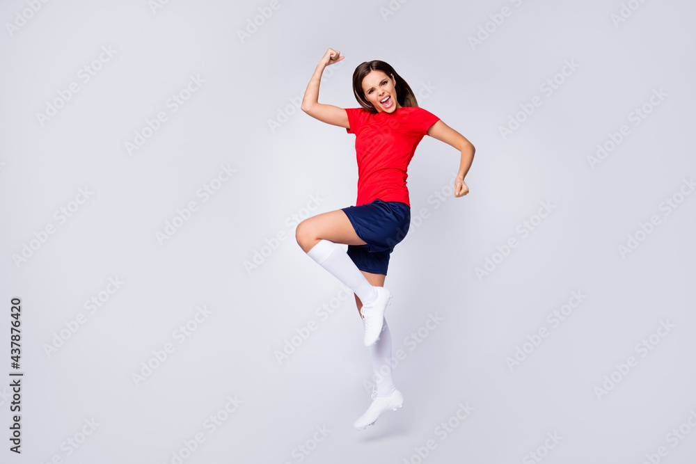 Full body profile photo of joy lady player soccer team jump up fists league leader native country win wear football uniform t-shirt shorts cleats socks isolated white color background