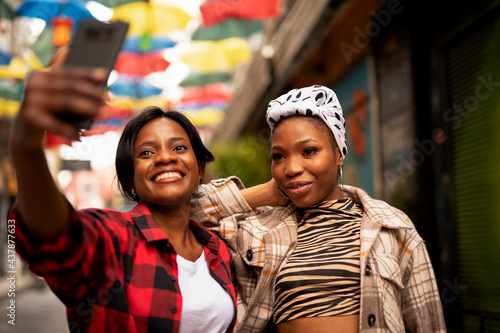 Portrait of a happy smiling female friends. Women taking selfie photo