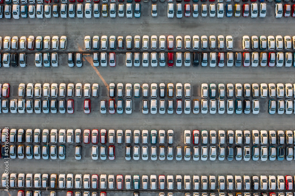 Aerial top down view of brand new cars at the logistics center, near the factory. Ready to export or import. Car parking lot.