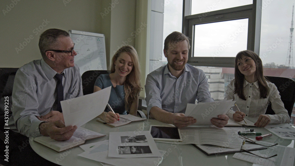 Team of architects discussing new project together in office
