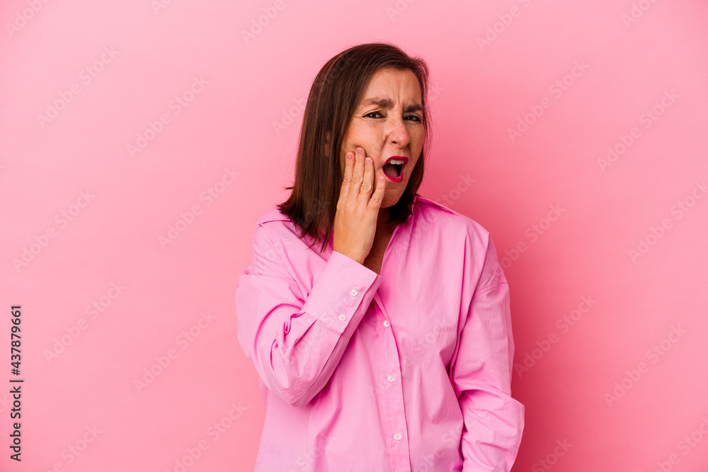 Middle age caucasian woman isolated on pink background having a strong teeth pain, molar ache. Middle age caucasian woman isolated on pink background having a strong teeth pain, molar ache.