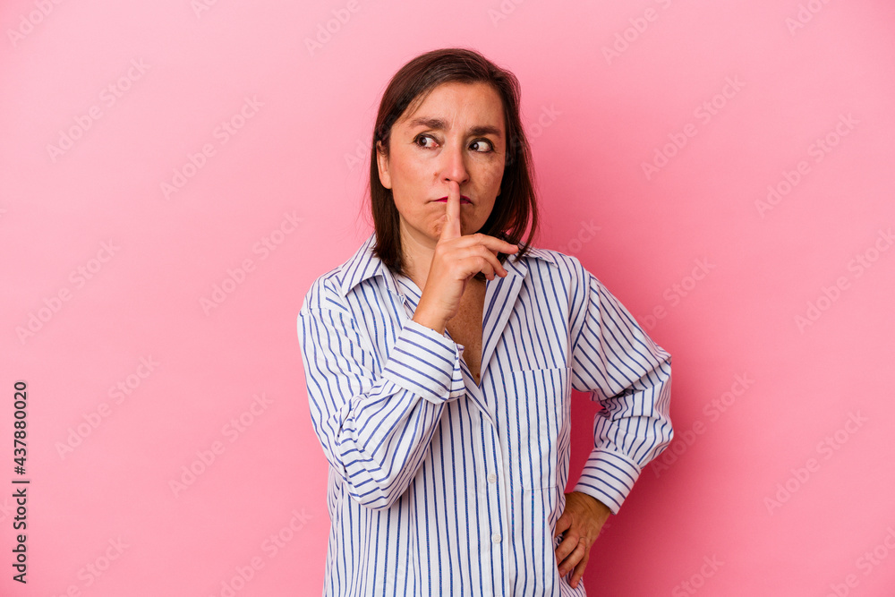 Middle age caucasian woman isolated on pink background keeping a secret or asking for silence. Middle age caucasian woman isolated on pink background keeping a secret or asking for silence.