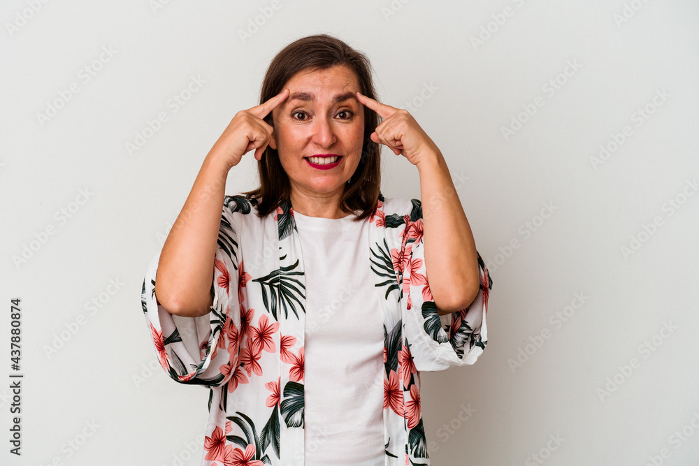 Middle age caucasian woman isolated on white background focused on a task, keeping forefingers pointing head. Middle age caucasian woman isolated on white background focused on a task, keeping forefingers pointing head.