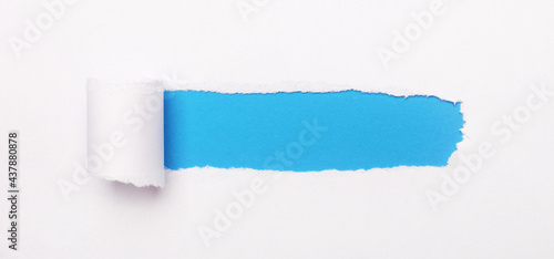On a bright blue background, white paper with a torn stripe and a place to insert the text. Template