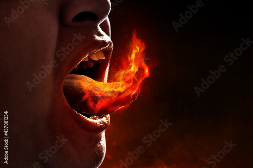 Young man eating spicy food
