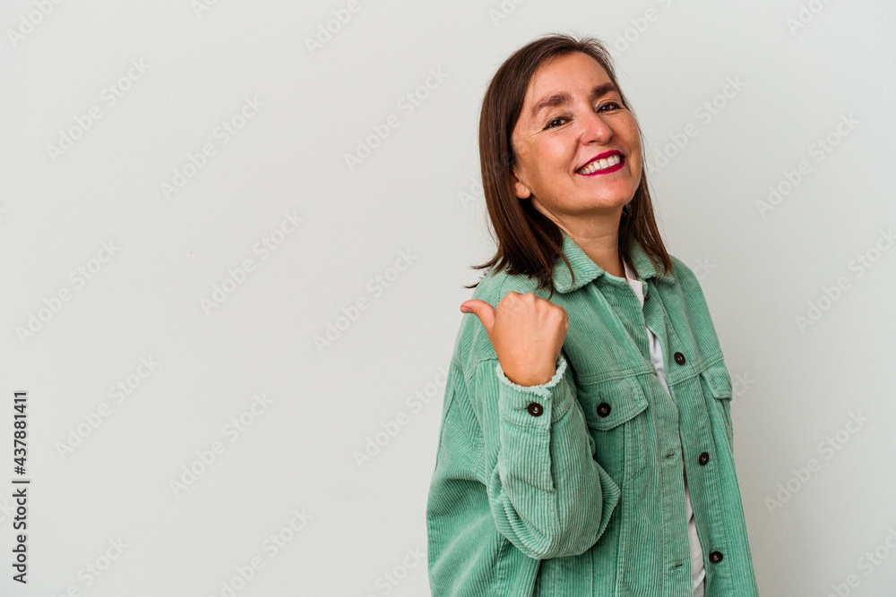 Middle age caucasian woman isolated on white background points with thumb finger away, laughing and carefree. Middle age caucasian woman isolated on white background points with thumb finger away, laughing and carefree.