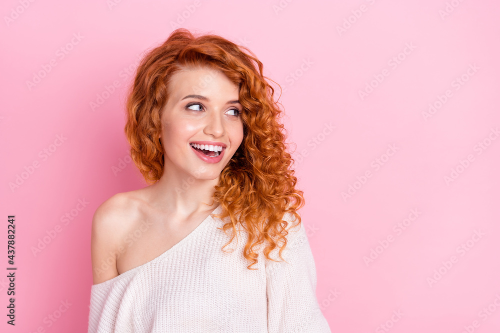 Photo portrait of red curly haired girl smiling in sweater with off-shoulder amazed looking copyspace isolated pastel pink color background Photo portrait of red curly haired girl smiling in sweater with off-shoulder amazed looking copyspace isolated pastel pink color background
