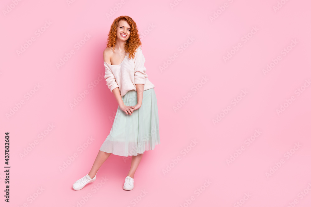 Full length body size photo of pretty girl with red hair wearing spring outfit smiling happy isolated on pastel pink color background Full length body size photo of pretty girl with red hair wearing spring outfit smiling happy isolated on pastel pink color background