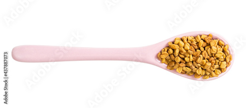 ceramic spoon with fenugreek seeds isolated