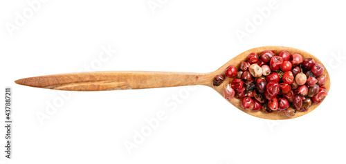top view of wood spoon with pink peppercorns