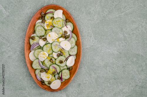 Salad of cucumbers, cheese, capers and lemon zest