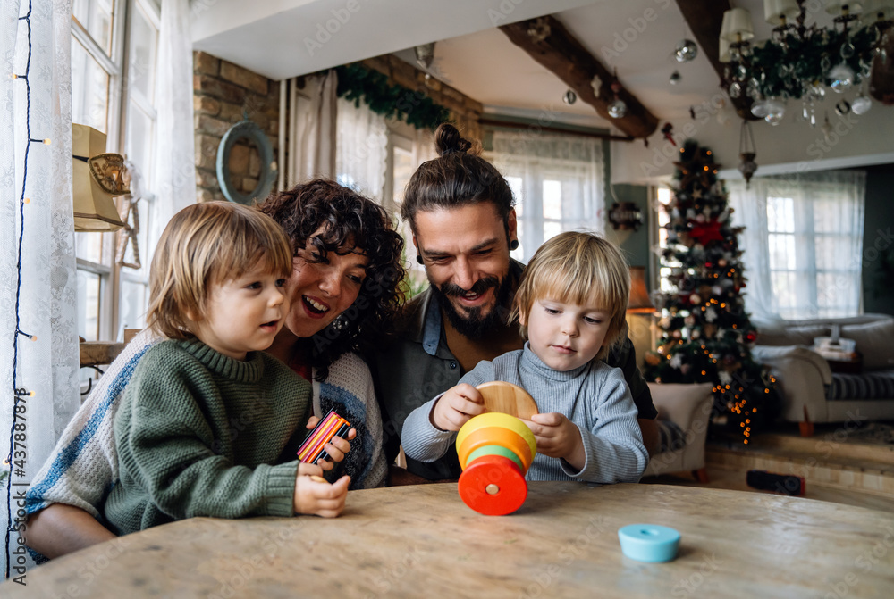 Fototapeta premium Happy family having fun time at home, parents playing with children.