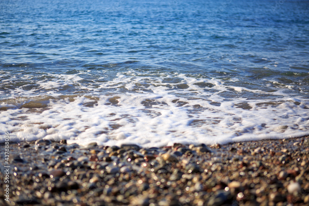 Waves washing over gravel beach, macro shot. Waves washing over gravel beach, macro shot.