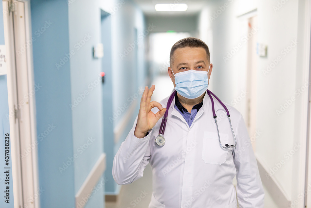 Happy cheerful male doctor is showing ok sign making circle with fingers. Gesture of approval. Happy cheerful male doctor is showing ok sign making circle with fingers. Gesture of approval.