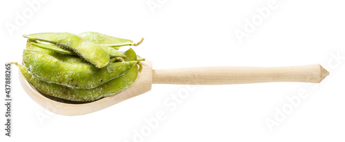 Edamame (unripe soybeans) pods in wooden spoon photo