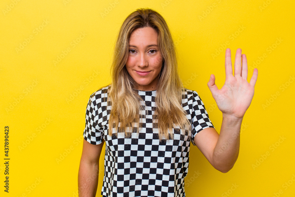 Young australian woman isolated smiling cheerful showing number five with fingers. Young australian woman isolated smiling cheerful showing number five with fingers.