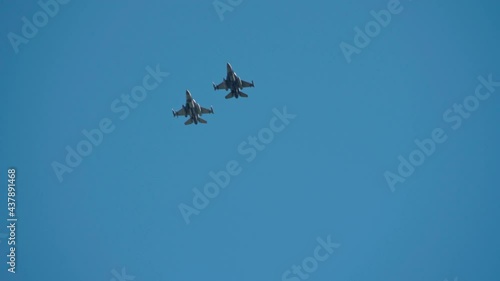 A squadron of F 16 military fighters, on parade, fly by quickly in figures, demonstrating power and strength. photo