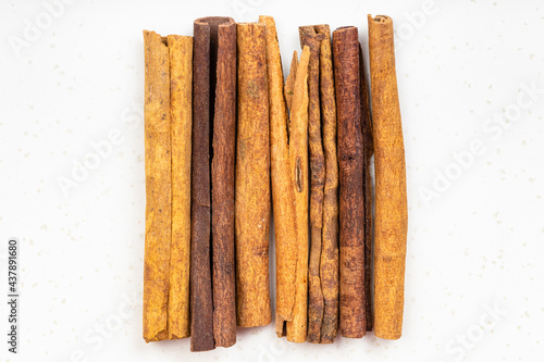 view of several sticks of cassia cinnamon on gray photo