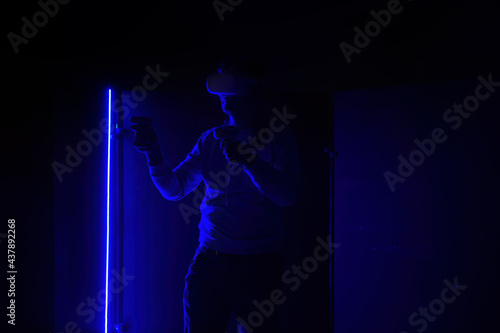 Man in virtual reality headset with joysticks © Mulderphoto