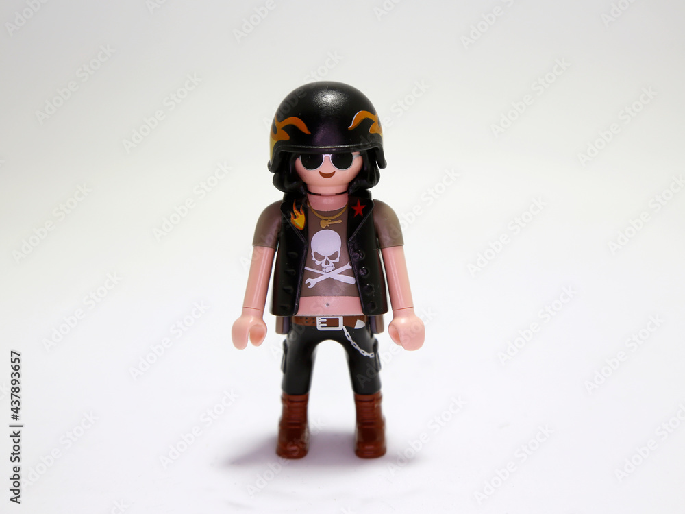 Playmobil doll. Motorcyclist. Rocker. Heavy Metal. Rude man. Harley Davison  style motorcyclist. Man with skull shirt. Motorcycle helmet. Sunglasses.  Toy for children. Collectible figure. Isolated. Stock Photo | Adobe Stock