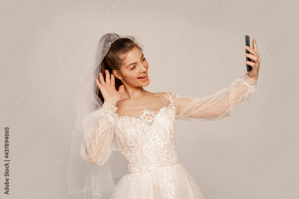 happy bride waving hand while taking selfie isolated on grey with lilac shade happy bride waving hand while taking selfie isolated on grey with lilac shade