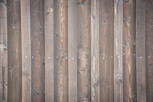 Wooden wall with coarse grained wood and nails in a row, for bacgrounds, concepts and texture