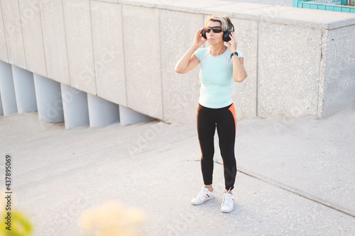 active seniors woman listen music after fitness workout in the city photo