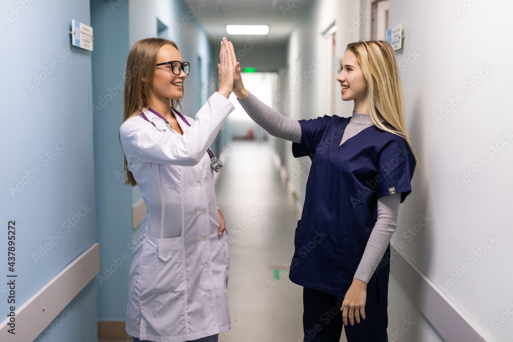 Doctors Team of Surgery gives High Five motivation in a clinic Doctors Team of Surgery gives High Five motivation in a clinic