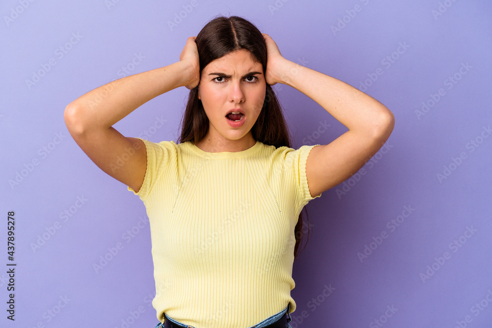Young caucasian woman isolated on purple background screaming with rage. Young caucasian woman isolated on purple background screaming with rage.