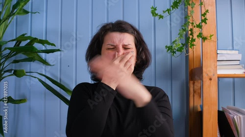 Old woman frowns at the bad smell in the room. Spoiled air.