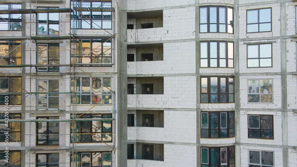 Aerial view of high residential apartment building under construction. Real estate development.
Aerial view of high residential apartment building under construction. Real estate development.