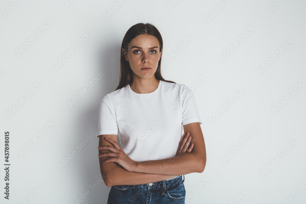 Cheerful woman in basic t-shirt smiling at camera