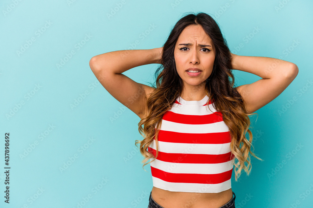 Young mexican woman isolated on blue background touching back of head, thinking and making a choice. Young mexican woman isolated on blue background touching back of head, thinking and making a choice.