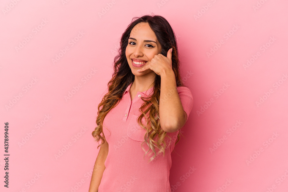 Young mexican woman isolated on pink background showing a mobile phone call gesture with fingers. Young mexican woman isolated on pink background showing a mobile phone call gesture with fingers.
