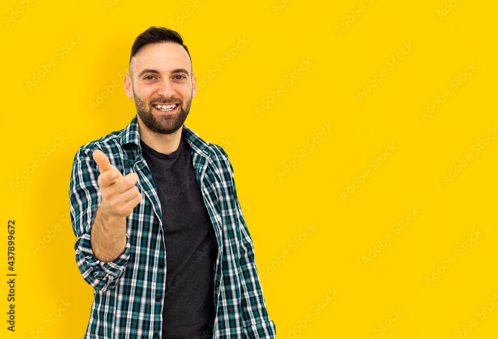 Young man in casual clothes on yellow colored background indicates goal achievement - concept of positivity and motivation. Young man in casual clothes on yellow colored background indicates goal achievement - concept of positivity and motivation.