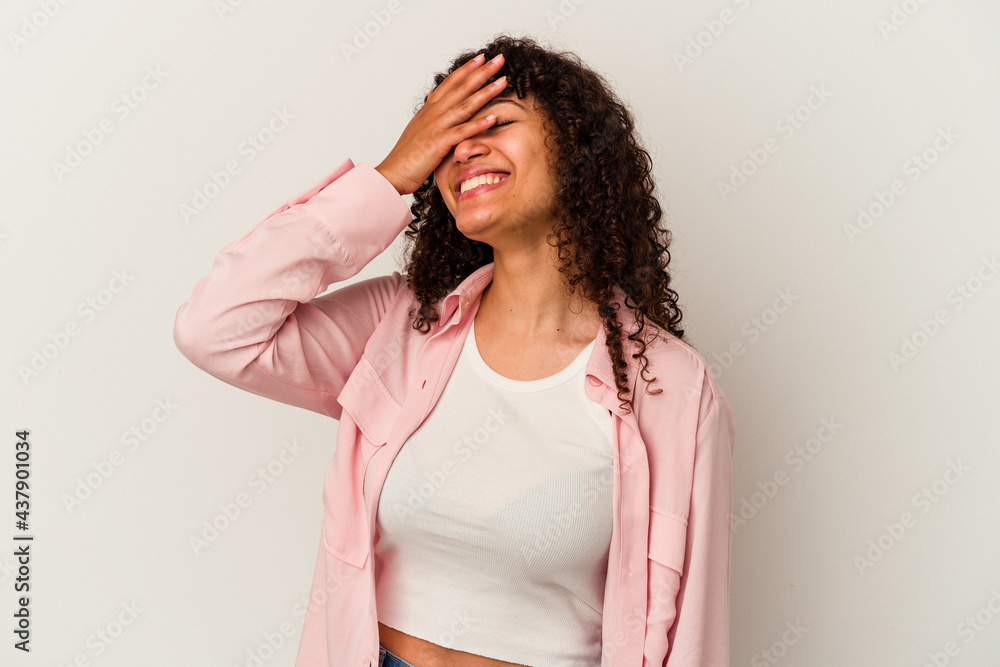 Young mixed race woman isolated on white background laughs joyfully keeping hands on head. Happiness concept. Young mixed race woman isolated on white background laughs joyfully keeping hands on head. Happiness concept.
