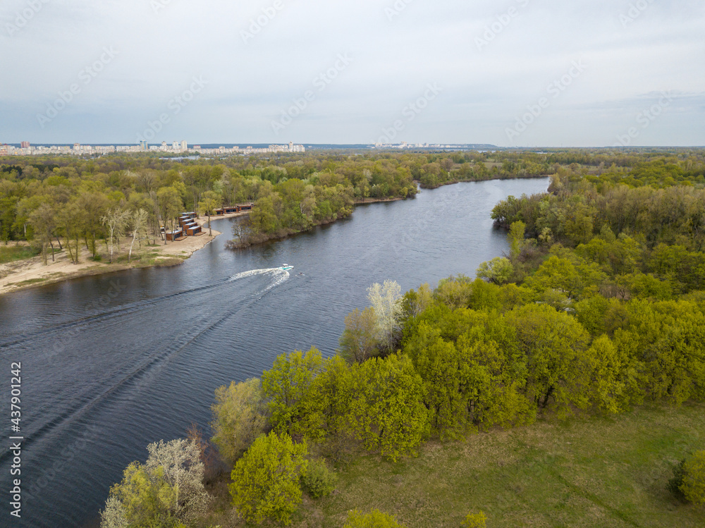 Fototapeta premium Motor boat with water skis on the river. Aerial drone view.