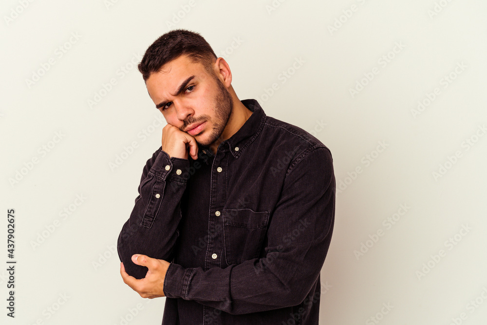 Young caucasian man isolated on white background tired of a repetitive task. Young caucasian man isolated on white background tired of a repetitive task.