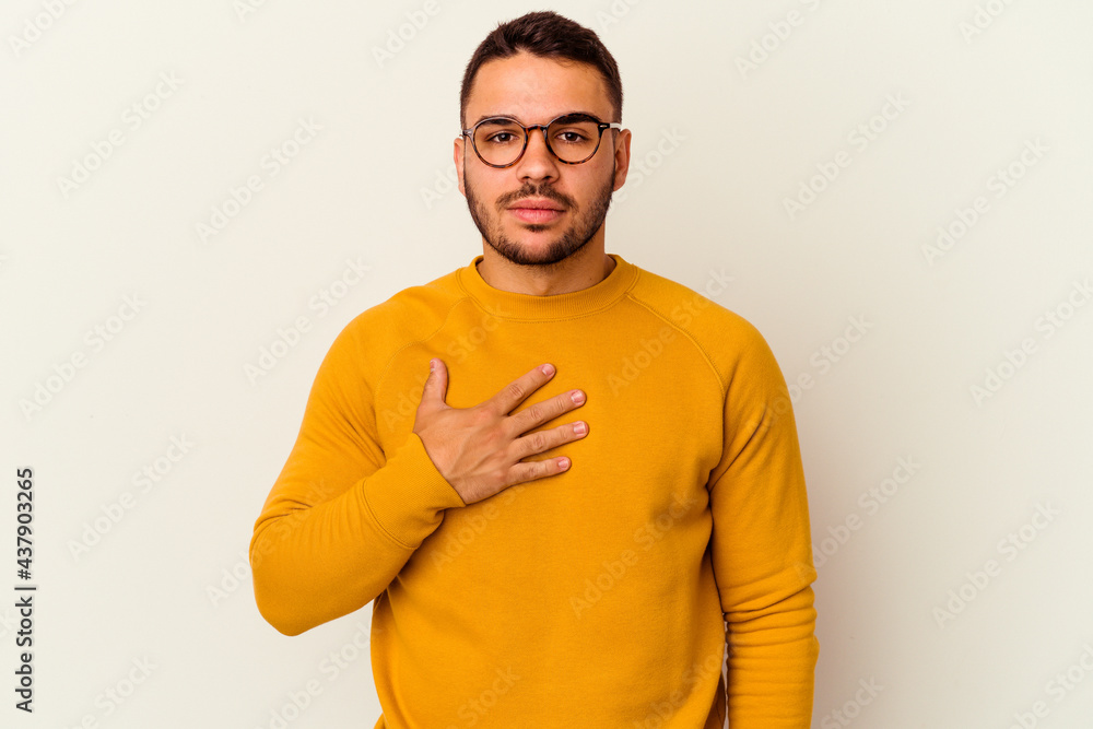 Young caucasian man isolated on white background taking an oath, putting hand on chest. Young caucasian man isolated on white background taking an oath, putting hand on chest.