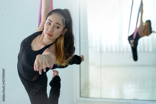 Pretty woman doing aerial dance practice in hammock at studio © chomplearn_2001