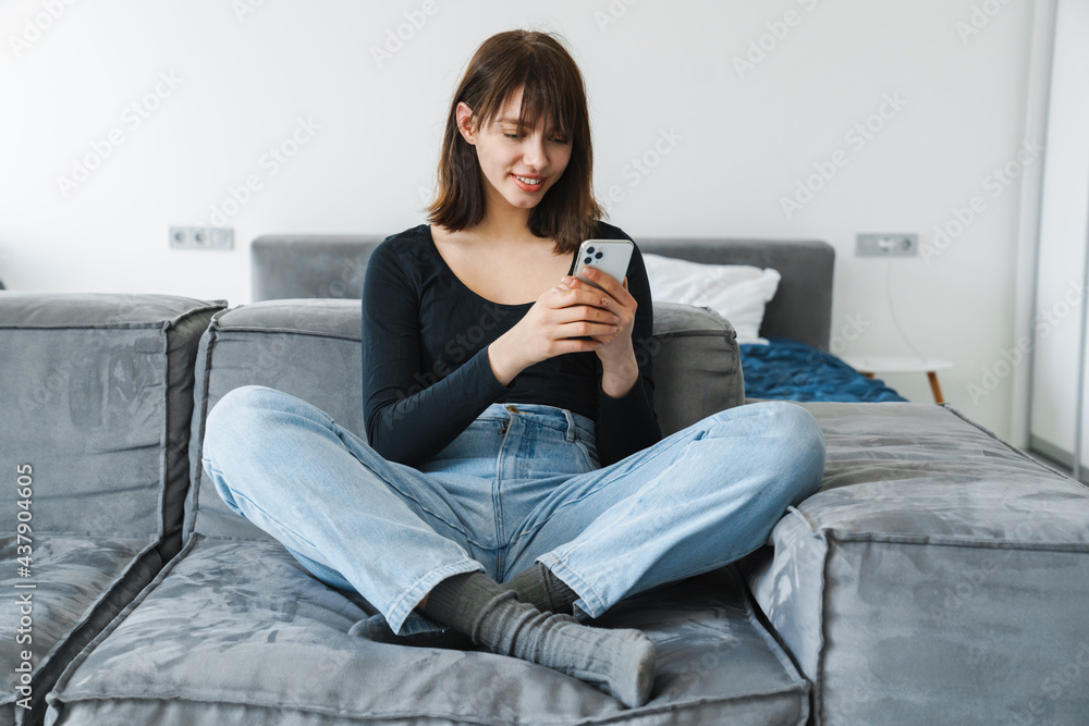 Smiling young woman using mobile phone Smiling young woman using mobile phone