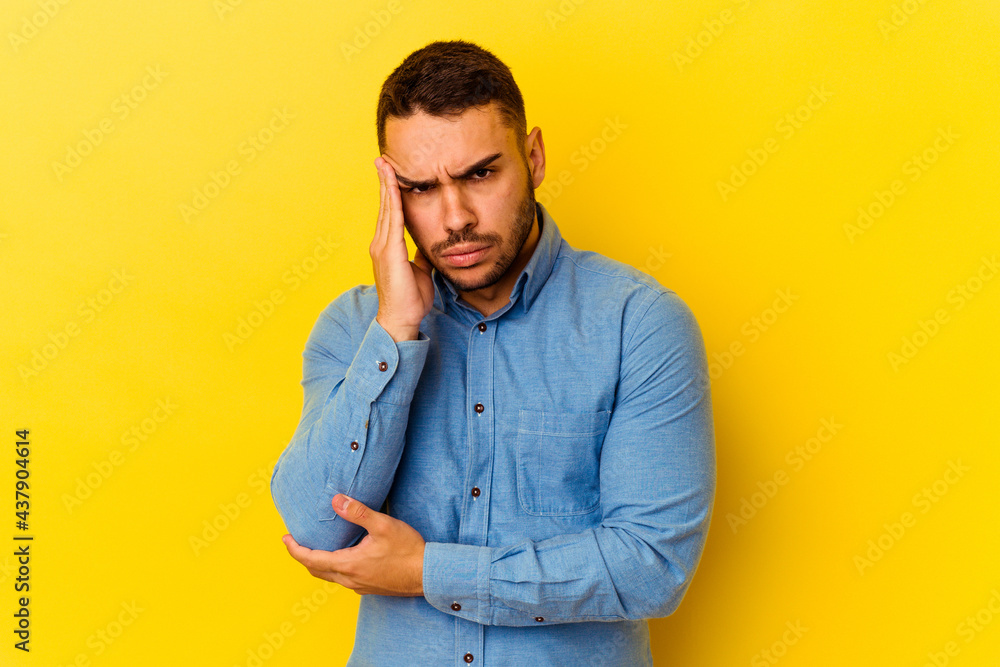 Young caucasian man isolated on yellow background blows cheeks, has tired expression. Facial expression concept. Young caucasian man isolated on yellow background blows cheeks, has tired expression. Facial expression concept.