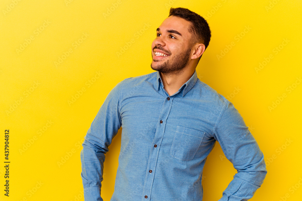 Young caucasian man isolated on yellow background relaxed and happy laughing, neck stretched showing teeth. Young caucasian man isolated on yellow background relaxed and happy laughing, neck stretched showing teeth.