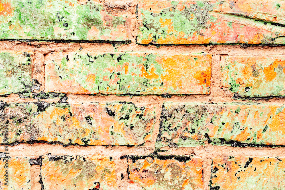 Orange brick wall with white spots. Background of orange bricks Orange brick wall with white spots. Background of orange bricks